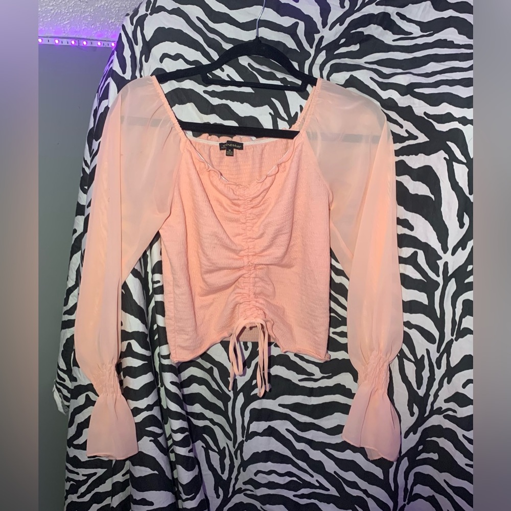 Pale pink blouse with square neckline and flouncy sleeves